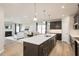 Open-concept kitchen flows into the living room, featuring a large island and stainless steel appliances, great for gatherings at 198 Glen Hollow Dr, Raleigh, NC 27604