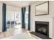 Living room with a fireplace and sliding glass doors leading to an outdoor patio, offering indoor-outdoor living at 198 Glen Hollow Dr, Raleigh, NC 27604