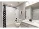 Bathroom featuring a shower-tub combo with marble-style tiling and a single sink vanity with white countertop at 199 Glen Hollow Dr, Raleigh, NC 27604
