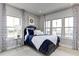 Comfortable bedroom with bright windows, blue bedding, and patterned curtains at 199 Glen Hollow Dr, Raleigh, NC 27604