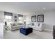 A Bonus room with neutral colors, a large ottoman, and many windows to view the outdoors at 199 Glen Hollow Dr, Raleigh, NC 27604