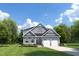 Charming two-story home with a well-manicured lawn, complemented by a two-car garage and inviting front porch at 199 Glen Hollow Dr, Raleigh, NC 27604