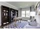 Home office with built-in bookshelves and a decorative rug in front of a window at 199 Glen Hollow Dr, Raleigh, NC 27604