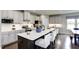 Open kitchen with white cabinets, stainless steel appliances, a large island with seating, and dining area at 199 Glen Hollow Dr, Raleigh, NC 27604