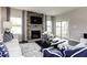 Comfortable living room showcasing a decorative fireplace and a sliding door leading to a covered porch at 199 Glen Hollow Dr, Raleigh, NC 27604
