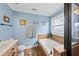 Well-lit bathroom with a soaking tub, tiled accents, and decorative fixtures at 2027 River Grove Ln, Knightdale, NC 27545