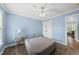 Cozy bedroom with carpet flooring, ceiling fan, and natural light makes it a perfect place to unwind and relax at 2027 River Grove Ln, Knightdale, NC 27545