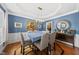 Stylish dining room with blue walls, modern light fixture, and butler's pantry at 2027 River Grove Ln, Knightdale, NC 27545