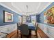 Formal dining room with blue walls, hardwood flooring, and modern chandelier at 2027 River Grove Ln, Knightdale, NC 27545