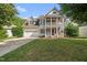 Charming two-story home featuring a welcoming front porch, well-manicured lawn, and attached two car garage at 2027 River Grove Ln, Knightdale, NC 27545