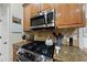 Stove area featuring stainless steel appliances, gas range, granite countertops, and a decorative backsplash at 2027 River Grove Ln, Knightdale, NC 27545