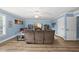 Bright living room boasts a modern ceiling fan, hardwood floors and cozy furniture for relaxing and entertaining at 2027 River Grove Ln, Knightdale, NC 27545