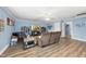 Bright living room boasts a modern ceiling fan, hardwood floors and cozy furniture for relaxing and entertaining at 2027 River Grove Ln, Knightdale, NC 27545