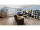 Spacious living room featuring a large sectional couch, ceiling fan, and plenty of room to relax and unwind at 2027 River Grove Ln, Knightdale, NC 27545