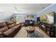 Spacious living room featuring a large sectional couch, ceiling fan, and plenty of room to relax and unwind at 2027 River Grove Ln, Knightdale, NC 27545