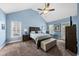Large primary bedroom featuring vaulted ceilings, bedside lamps, and a cozy chair at 2027 River Grove Ln, Knightdale, NC 27545