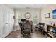Comfortable home office with two windows, a modern desk, and dual seating provides an ideal work environment at 2027 River Grove Ln, Knightdale, NC 27545