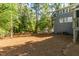 Home's spacious backyard features mature trees and rear exterior at 205 Northfield Dr, Raleigh, NC 27609