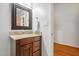 Bathroom features wooden vanity with granite countertop and decorative mirror at 205 Northfield Dr, Raleigh, NC 27609