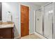 Bathroom features wooden vanity, tile floor, and glass-enclosed shower at 205 Northfield Dr, Raleigh, NC 27609