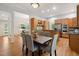 Dining room with hardwood floors, gray chairs, and view to kitchen at 205 Northfield Dr, Raleigh, NC 27609