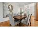 Open dining area with hardwood floors, gray chairs, and view to entrance at 205 Northfield Dr, Raleigh, NC 27609