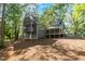 Rear view of the home featuring large backyard, wood deck, and screened in porch at 205 Northfield Dr, Raleigh, NC 27609