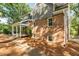 Side view of brick house with covered porch and a brick paved path at 205 Northfield Dr, Raleigh, NC 27609