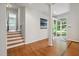 Light-filled foyer with hardwood floors and staircase and glass-paneled front door at 205 Northfield Dr, Raleigh, NC 27609