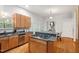 A kitchen with stainless appliances, granite counters, wood cabinets, and a gas cooktop on the island at 205 Northfield Dr, Raleigh, NC 27609