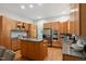 A kitchen with stainless appliances, granite countertops, wood cabinets, and a kitchen island at 205 Northfield Dr, Raleigh, NC 27609