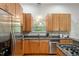 A kitchen with stainless steel appliances, granite countertops, wood cabinets, and a gas range at 205 Northfield Dr, Raleigh, NC 27609