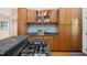 A modern kitchen with granite countertops, stainless appliances, and light wood cabinetry at 205 Northfield Dr, Raleigh, NC 27609