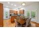 An open concept kitchen and dining area with a stainless fridge and wood cabinets at 205 Northfield Dr, Raleigh, NC 27609