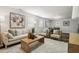 Bright living room featuring a sofa, two chairs, and a light-colored rug, creating an open and airy atmosphere at 205 Northfield Dr, Raleigh, NC 27609
