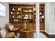 Comfortable seating area with built-in shelving, decorative accents, two chairs, and a geometric coffee table at 205 Northfield Dr, Raleigh, NC 27609