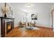 Living room has a fireplace, hardwood floors, and two comfy chairs around a coffee table at 205 Northfield Dr, Raleigh, NC 27609
