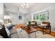 Inviting living room with hardwood floors, modern furniture, and a bay window at 205 Northfield Dr, Raleigh, NC 27609