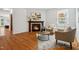 A living room featuring a fireplace, natural lighting, hardwood flooring, and neutral decor at 205 Northfield Dr, Raleigh, NC 27609