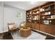Cozy seating area with two chairs, a geometric coffee table, and built-in shelving with decorative accents at 205 Northfield Dr, Raleigh, NC 27609