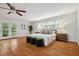 Spacious bedroom featuring hardwood floors, large windows, a ceiling fan, and a private balcony at 205 Northfield Dr, Raleigh, NC 27609