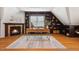 An office space with a gas fireplace, hardwood floors, and floor to ceiling bookshelves at 205 Northfield Dr, Raleigh, NC 27609