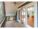 Relaxing screened-in porch with wooden floor and ceiling fan at 205 Northfield Dr, Raleigh, NC 27609