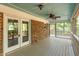 Spacious screened-in porch with wood floor, ceiling fan and brick exterior at 205 Northfield Dr, Raleigh, NC 27609