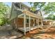 Back exterior of house with covered porch with steps and brick and grey siding at 205 Northfield Dr, Raleigh, NC 27609