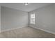 Vacant bedroom with neutral carpet and a window offering natural light at 2057 Big Falls Dr, Wendell, NC 27591