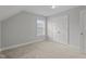 Vacant bedroom features neutral carpet, double door closet, and a window for natural light at 2057 Big Falls Dr, Wendell, NC 27591