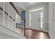 Welcoming foyer featuring hardwood floors, staircase, and view of the bright front door at 2057 Big Falls Dr, Wendell, NC 27591