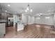 Open-concept kitchen and living area with stainless steel appliances and wood flooring at 2057 Big Falls Dr, Wendell, NC 27591