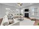 Bright and inviting living room with stylish furnishings, a fireplace, and a comfortable seating area at 2057 Big Falls Dr, Wendell, NC 27591